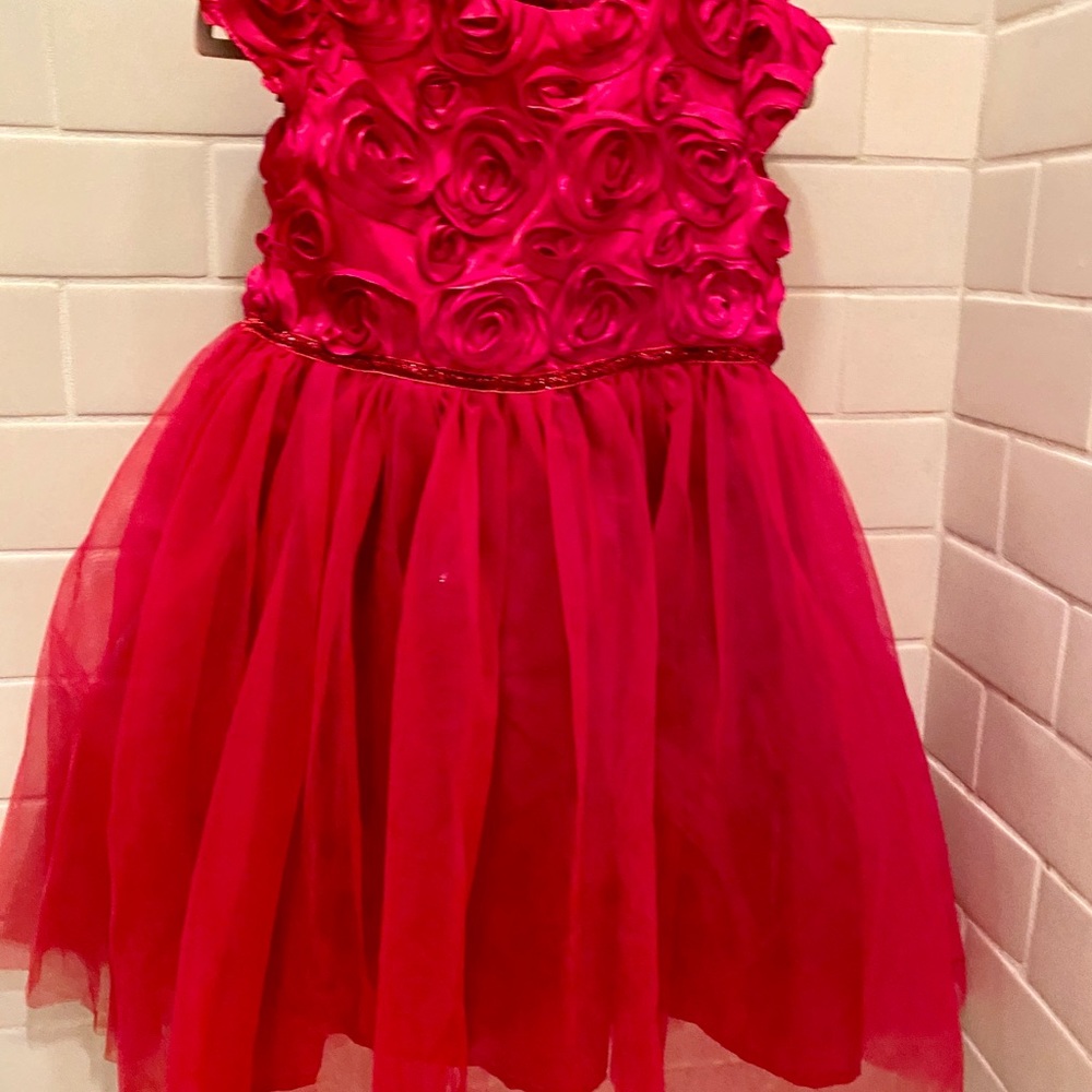 Red tulle A line dress with rose bud decoration.
